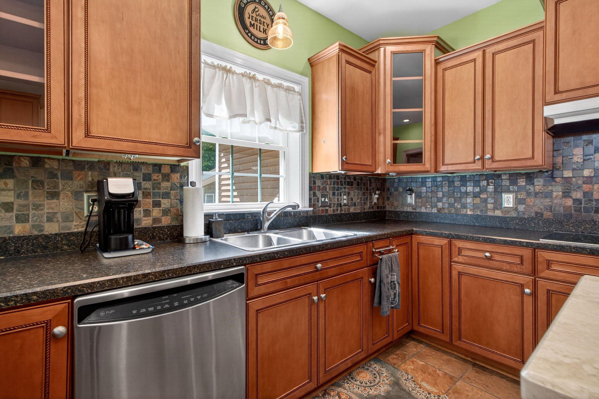 10878 Memory Road Harrington, DE 19952 - Photo 36 of 94 a kitchen with stainless steel appliances granite countertop a sink stove and cabinets