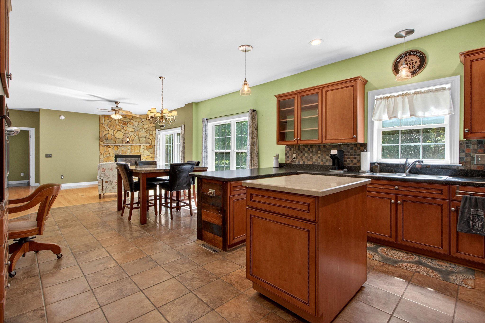 10878 Memory Road Harrington, DE 19952 - Photo 40 of 94 a kitchen with stainless steel appliances granite countertop a stove a sink a dining table and chairs with wooden floor