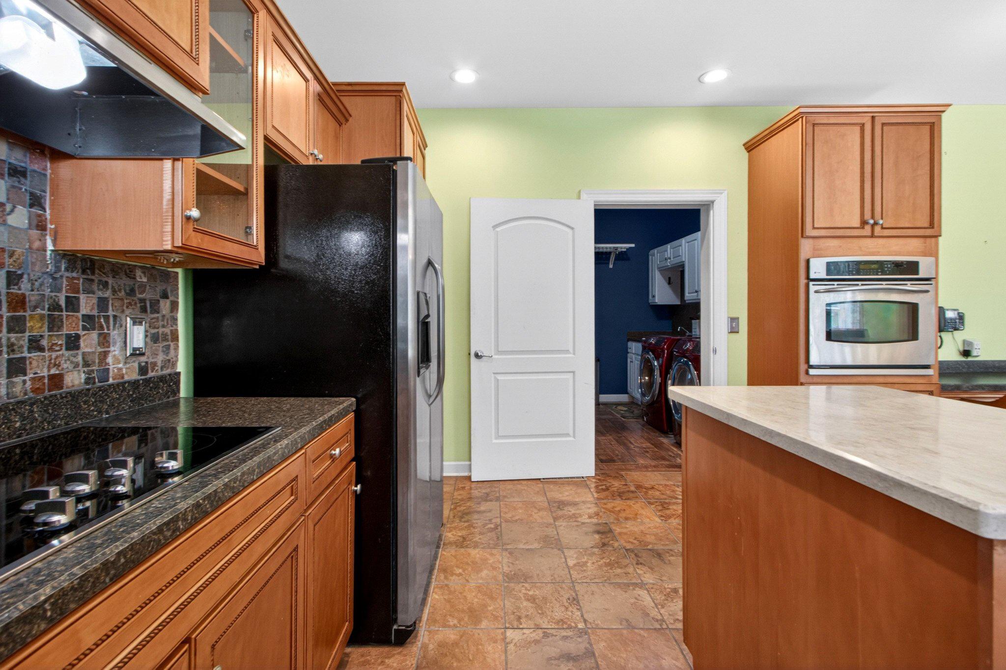 10878 Memory Road Harrington, DE 19952 - Photo 43 of 94 a kitchen with stainless steel appliances granite countertop a refrigerator and a stove