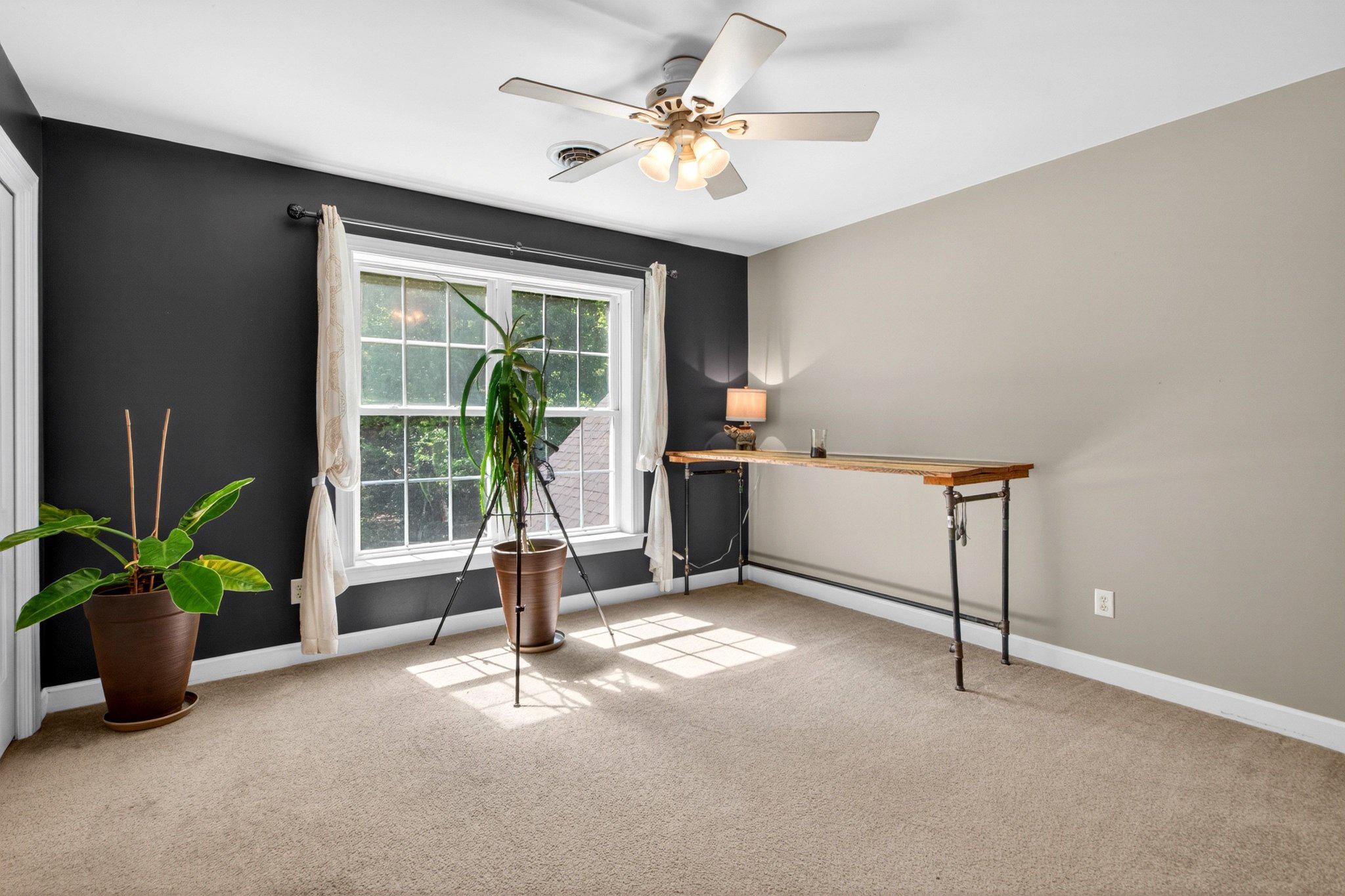 10878 Memory Road Harrington, DE 19952 - Photo 57 of 94 a living room with a balcony a ceiling fan and a potted plant