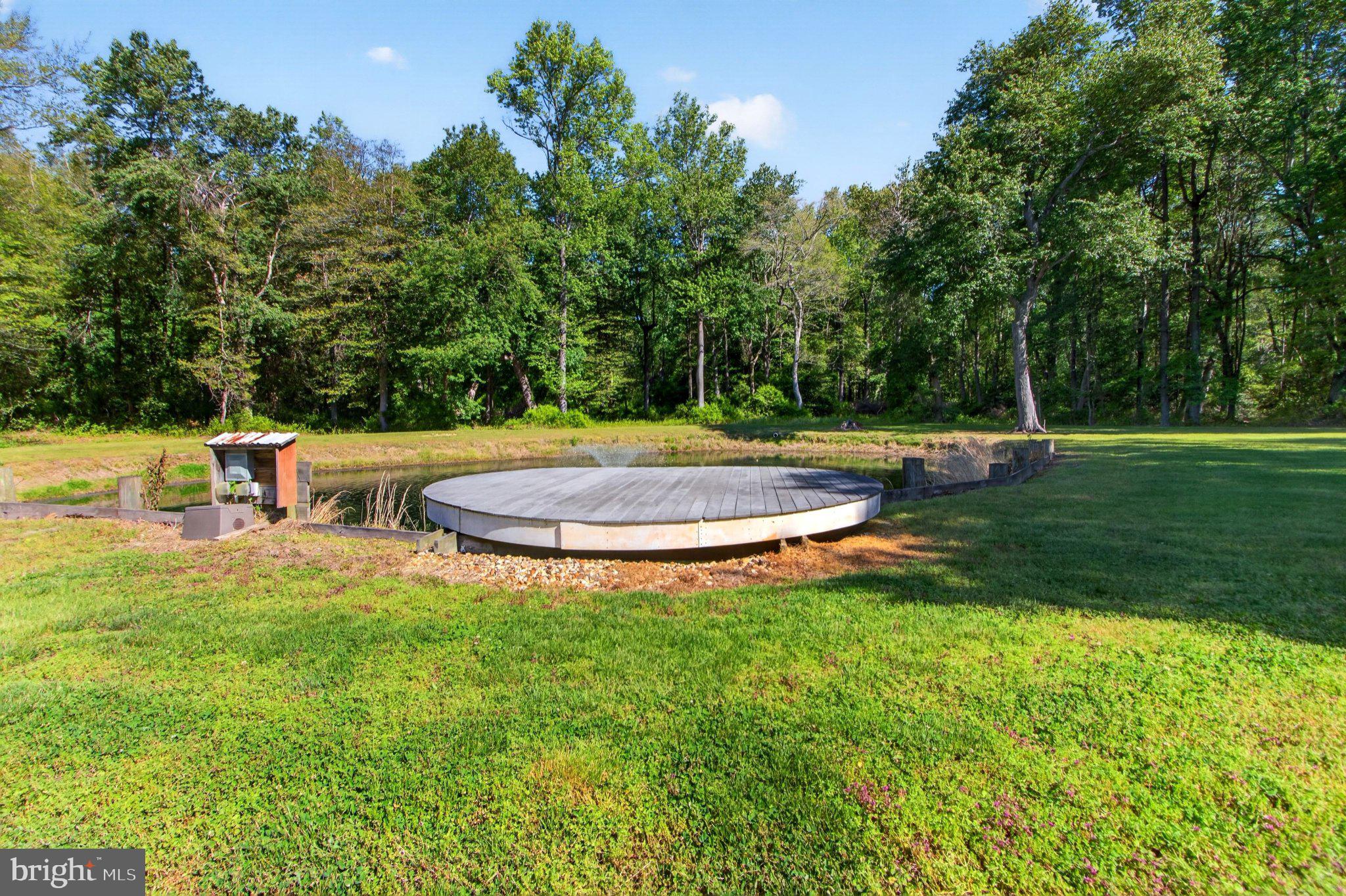 10878 Memory Road Harrington, DE 19952 - Photo 65 of 94 a view of a swimming pool with a yard