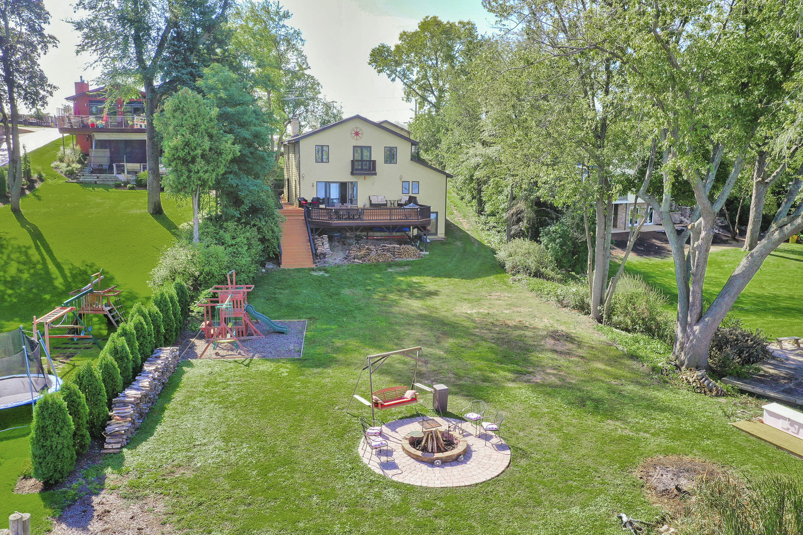 520 Bald Knob Road Johnsburg, IL 60051 - Photo 53 of 53 a view of a backyard with table and chairs potted plants and large tree