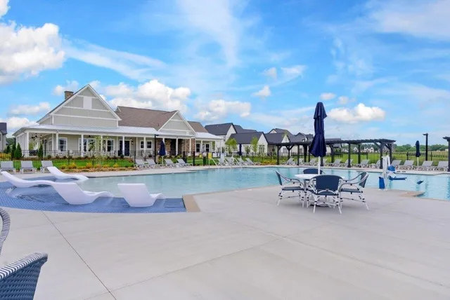 a view of a swimming pool with outdoor seating