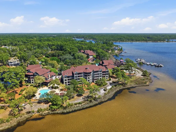 an aerial view of residential houses with outdoor space and trees