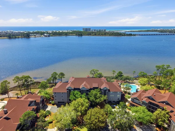 an aerial view of lake and residential houses with outdoor space