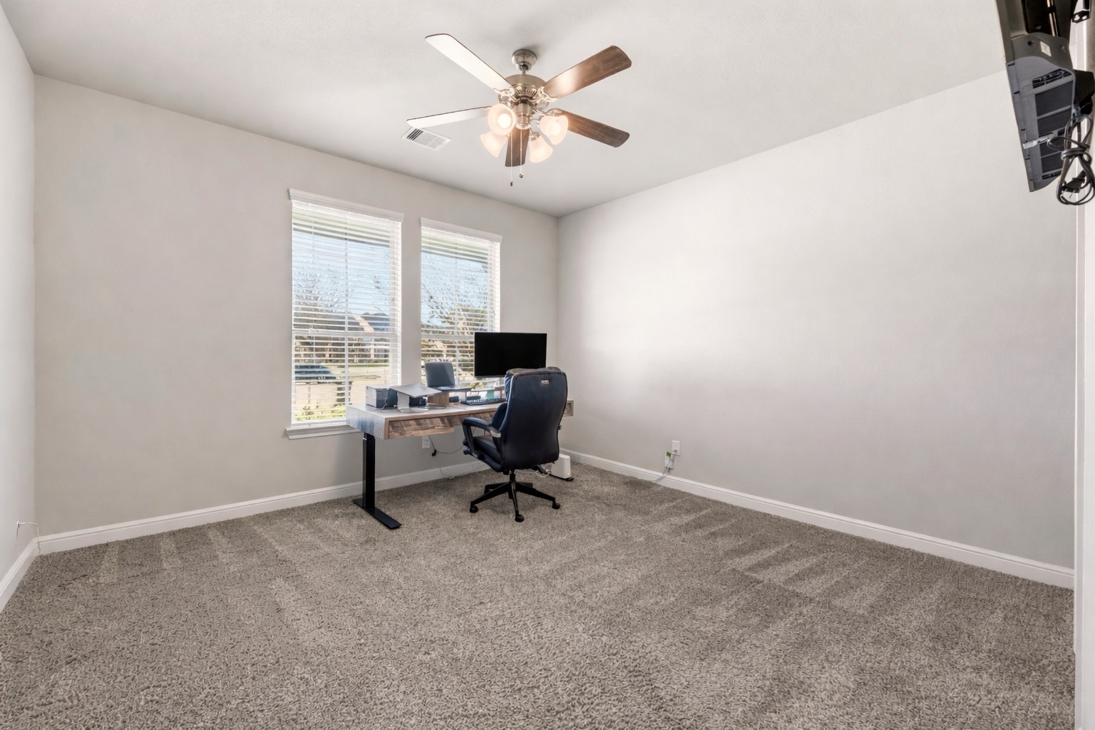 3319 Learning Tree Lane Rosenberg, TX 77471 - Photo 16 of 44 Whether for an in-law or a guest, the convenient first floor bedroom features an attached full bathroom, plush carpet and carpet padding, a ceiling fan and two wide windows. Everyone appreciates a gracious host!