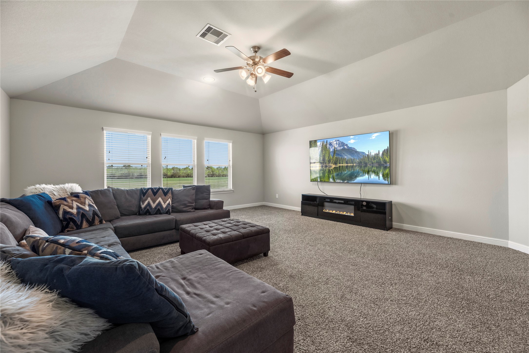 3319 Learning Tree Lane Rosenberg, TX 77471 - Photo 19 of 44 Experience the ultimate in modern living with this expansive upstairs game room, perfect for a home gym, telecommuting office, or dedicated learning space, offering endless flexibility to suit your lifestyle.