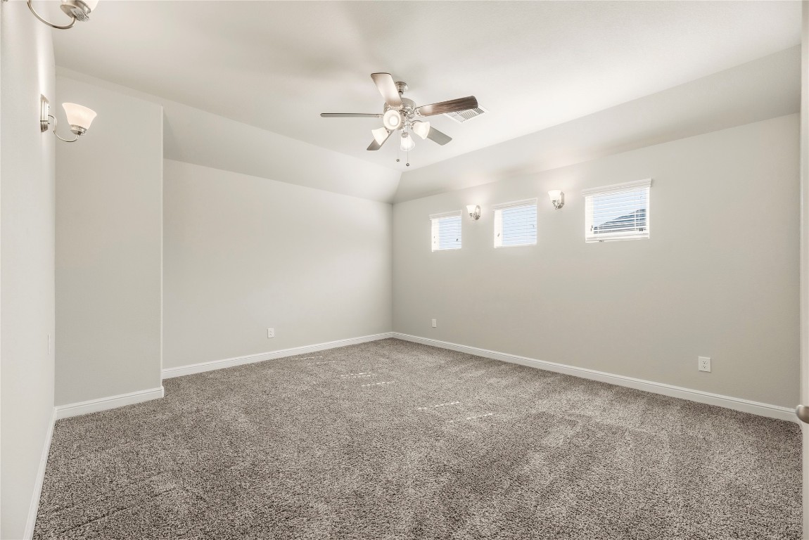 3319 Learning Tree Lane Rosenberg, TX 77471 - Photo 21 of 44 an empty room with chandelier fan and windows