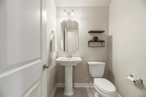 an empty room with chandelier fan and windows