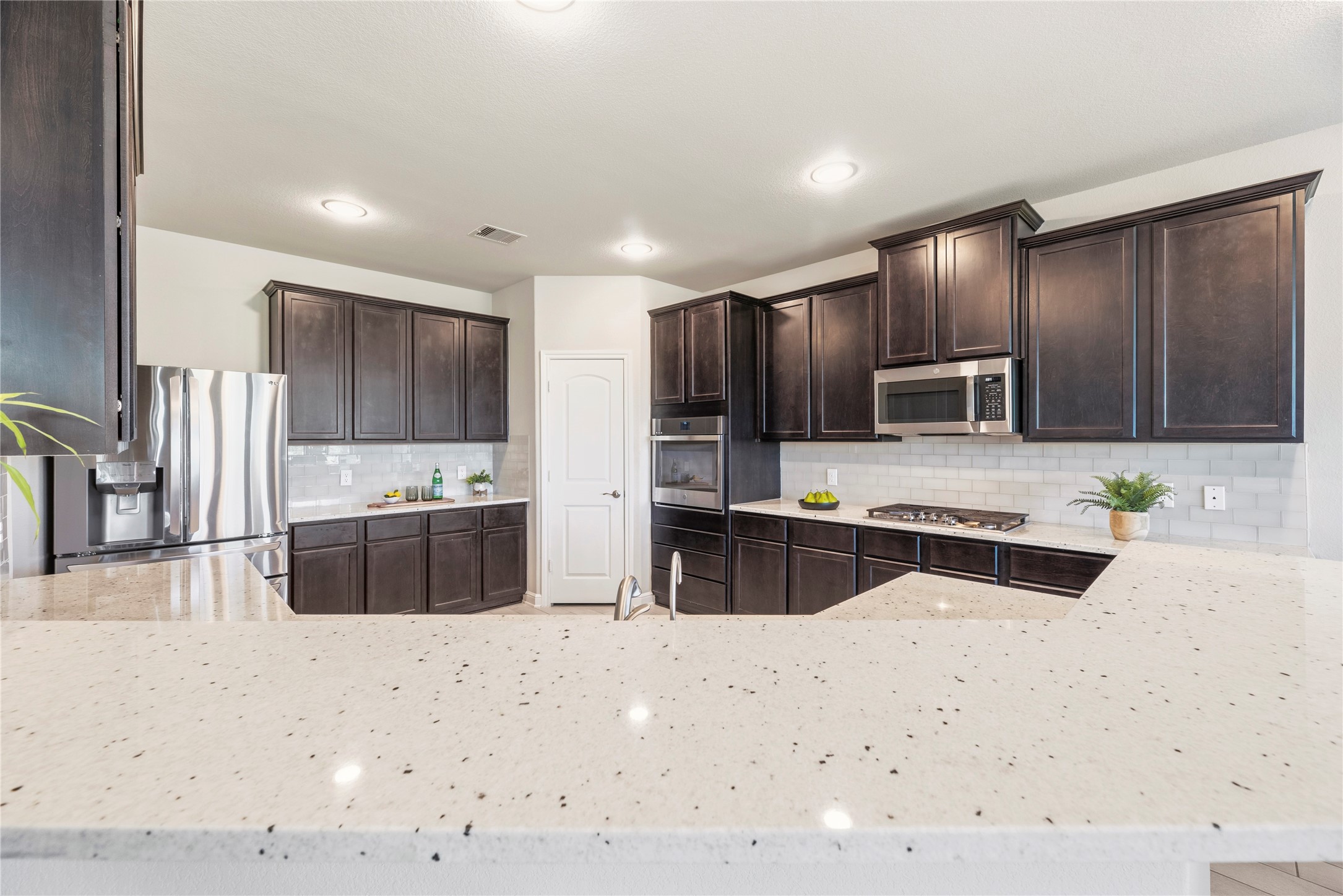 3319 Learning Tree Lane Rosenberg, TX 77471 - Photo 3 of 44 Experience the joy of cooking in this stunning gourmet kitchen, where sleek design meets practicality, making meal prep a breeze for both hectic mornings and lively evenings.