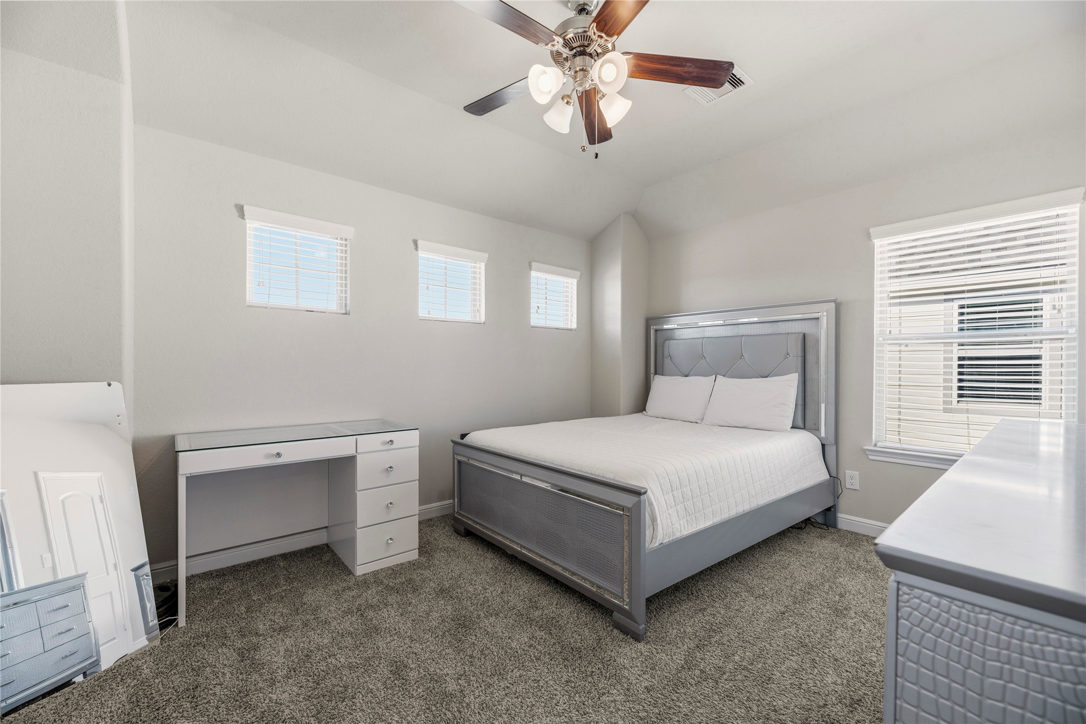 3319 Learning Tree Lane Rosenberg, TX 77471 - Photo 32 of 44 High ceilings with interesting angles provide a unique quality, while the neutral carpet contributes a fantastic backdrop for a variety of style preferences.