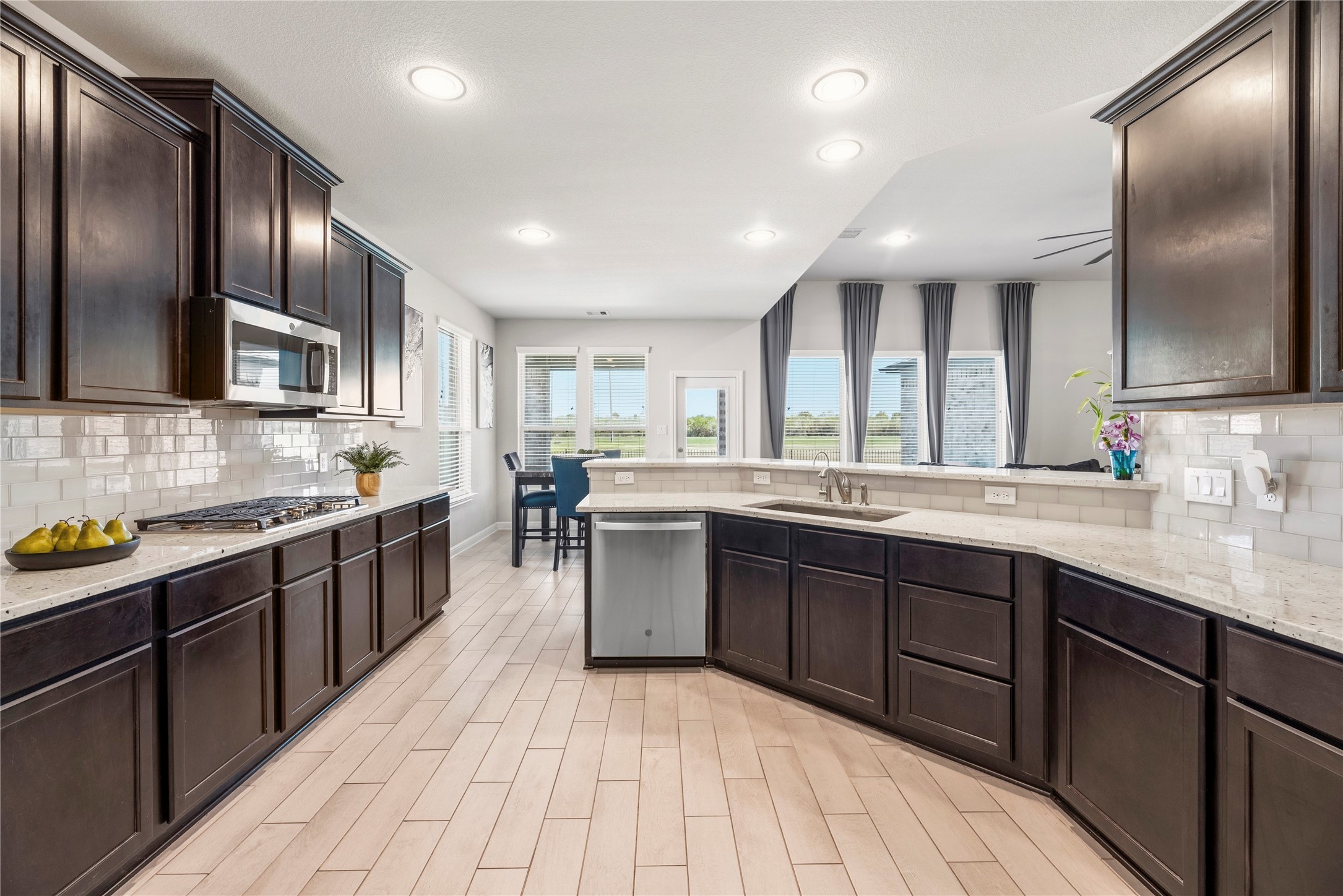 3319 Learning Tree Lane Rosenberg, TX 77471 - Photo 4 of 44 While preparing meals in this gourmet kitchen, effortlessly engage with guests in the breakfast area and living room, creating a seamless and inviting space for entertaining.