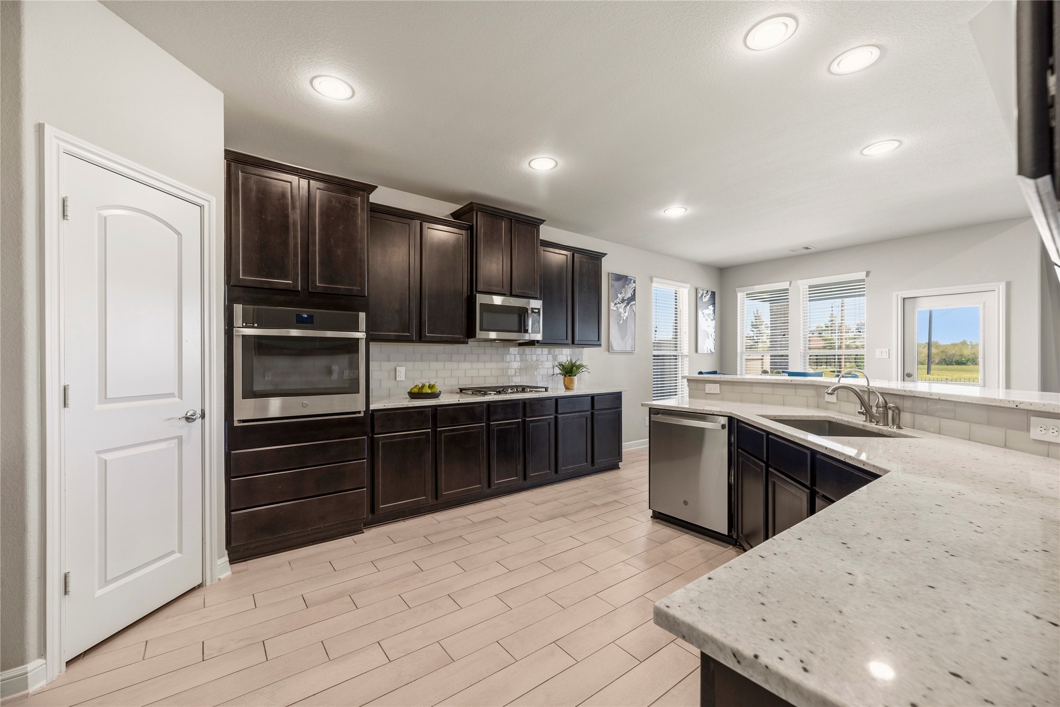 3319 Learning Tree Lane Rosenberg, TX 77471 - Photo 5 of 44 This modern kitchen dazzles with stainless-steel Energy Star appliances and stunning quartz countertops, perfectly blending style and efficiency for contemporary living.