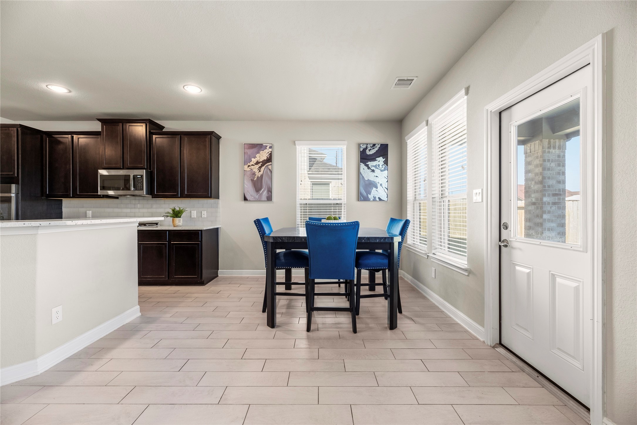 3319 Learning Tree Lane Rosenberg, TX 77471 - Photo 7 of 44 Enjoy stylish, bright family breakfasts in this charming dining area, perfect for savoring heart-shaped waffles while admiring the serene backyard view.