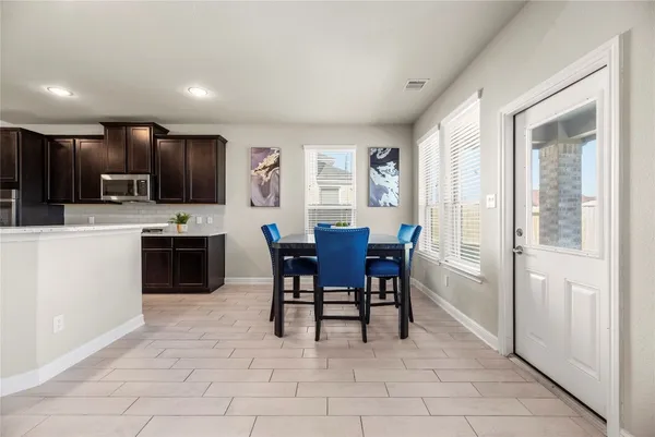 a view of kitchen with sink dining table and chairs