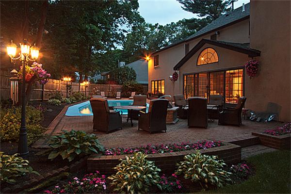14 Apache Trail Arlington, MA 02474 - Photo 24 of 29 a front view of a building with lots of flowers and trees