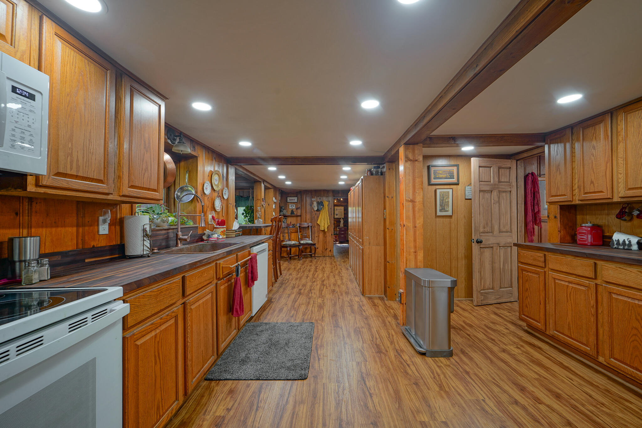 420 Price Creek Road Big Bar, CA 96010 - Photo 22 of 63 a kitchen with stainless steel appliances granite countertop wooden floors a stove a sink and a refrigerator