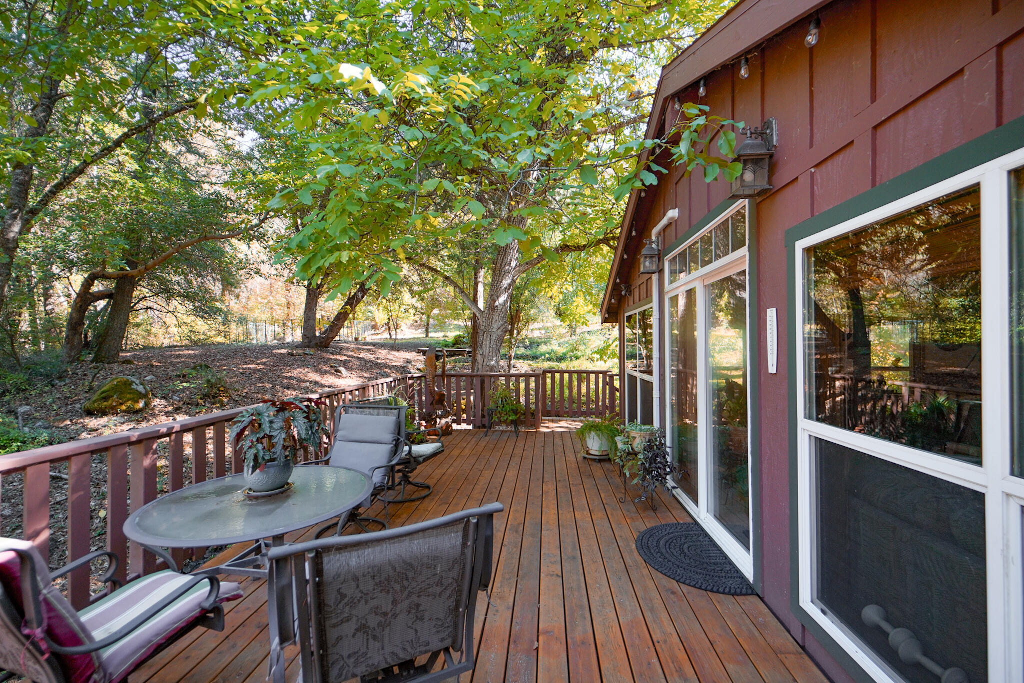 420 Price Creek Road Big Bar, CA 96010 - Photo 45 of 63 a view of a patio with couches table and chairs and wooden floor