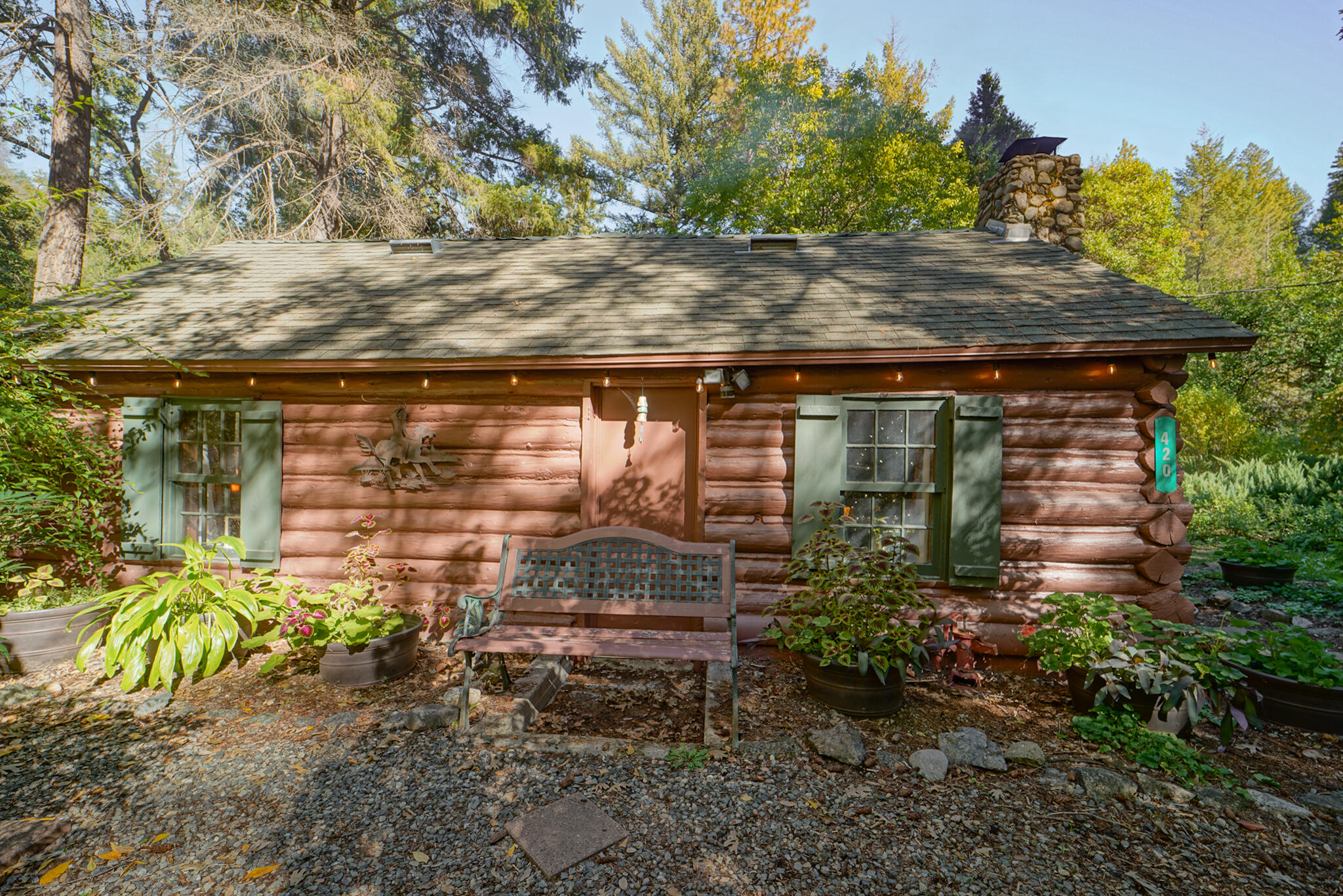 420 Price Creek Road Big Bar, CA 96010 - Photo 5 of 63 a backyard of a house with a tree and outdoor seating
