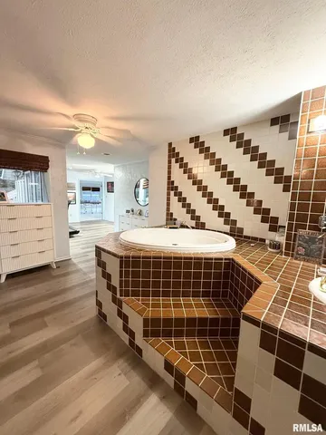 a bedroom with bed and wooden floor