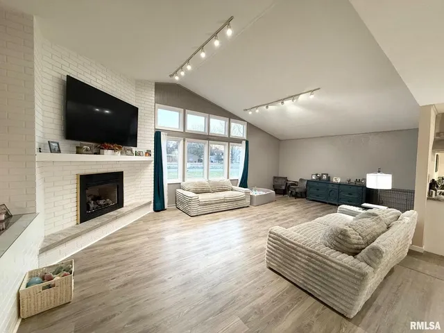 a living room with furniture flat screen tv and a fireplace