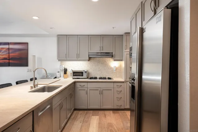 a kitchen with stainless steel appliances granite countertop a sink stove and refrigerator