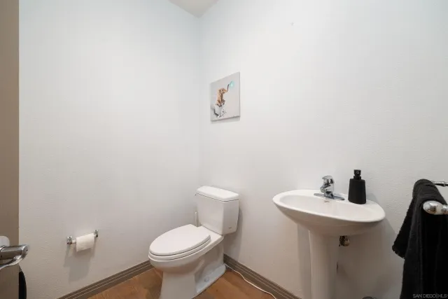 a bathroom with a sink toilet and a mirror