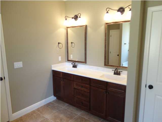 4644 Hermosa Road Crestview, FL 32539 - Photo 22 of 30 a bathroom with a double vanity sink and mirror