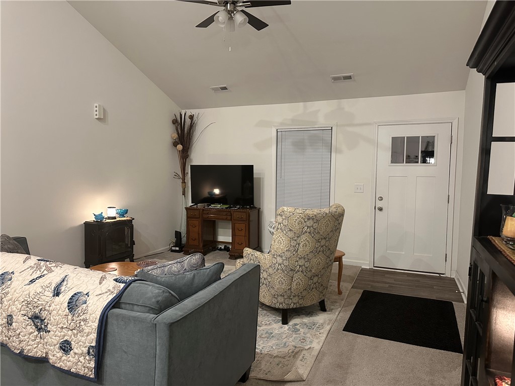 505 Blue Ridge Avenue Belton, SC 29627 - Photo 3 of 17 This inviting living area features a bright entryway and soaring vaulted ceilings, creating an airy ambiance.