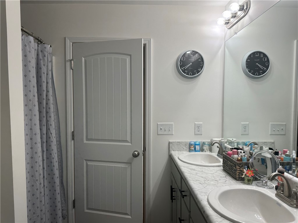 505 Blue Ridge Avenue Belton, SC 29627 - Photo 7 of 17 This bathroom features a double vanity and an elegantly framed mirror.