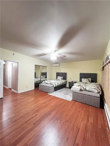 a spacious bedroom with a bed and a couch