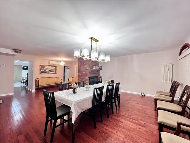 a view of a dining room with furniture wooden floor and chandelier