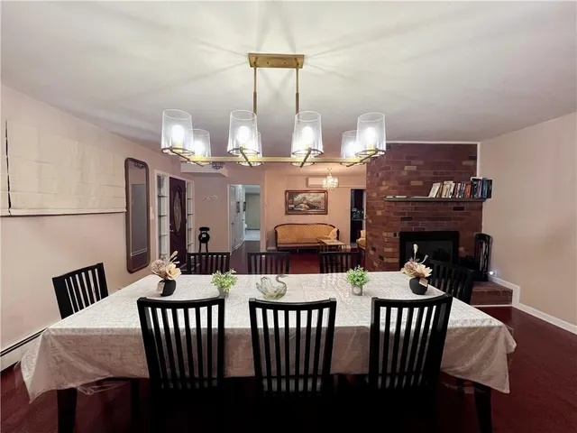 a view of a dining room with furniture and chandelier
