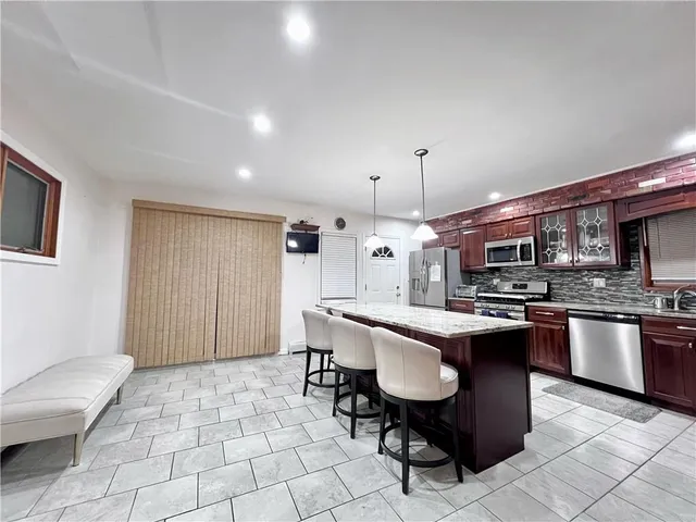 a kitchen with a sink a counter top space and stainless steel appliances