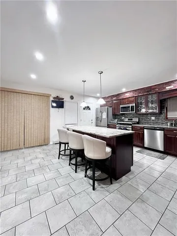 a kitchen with a sink dining table and chairs