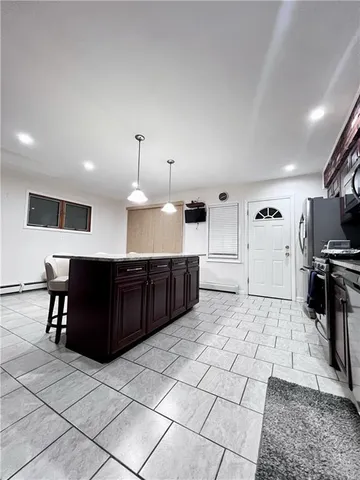 a large white kitchen with a large window and stainless steel appliances