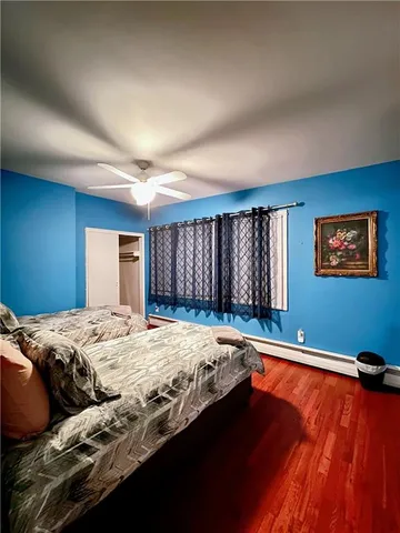 a bed sitting in a bedroom next to a window