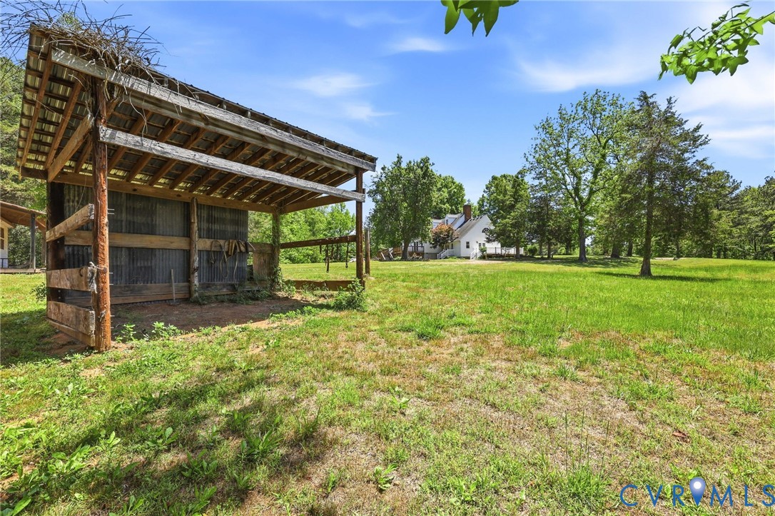 3355 Duke Road Powhatan, VA 23139 - Photo 43 of 67 a backyard of a house with lots of green space and garden
