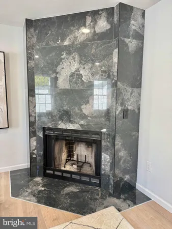a living room with a fireplace and a glass table