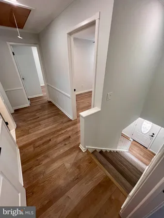 a view of an empty room and wooden floor