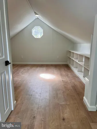 a view of a room with wooden floor and door