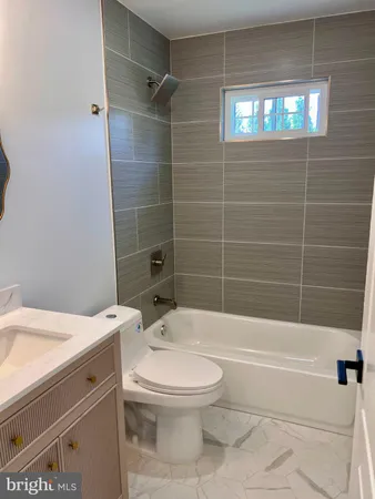 a bathroom with a toilet a sink and bathtub