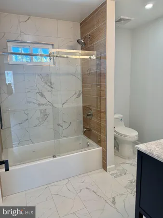 a bathroom with a bathtub and a toilet