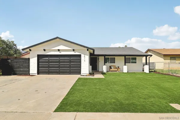 a front view of a house with a yard and porch