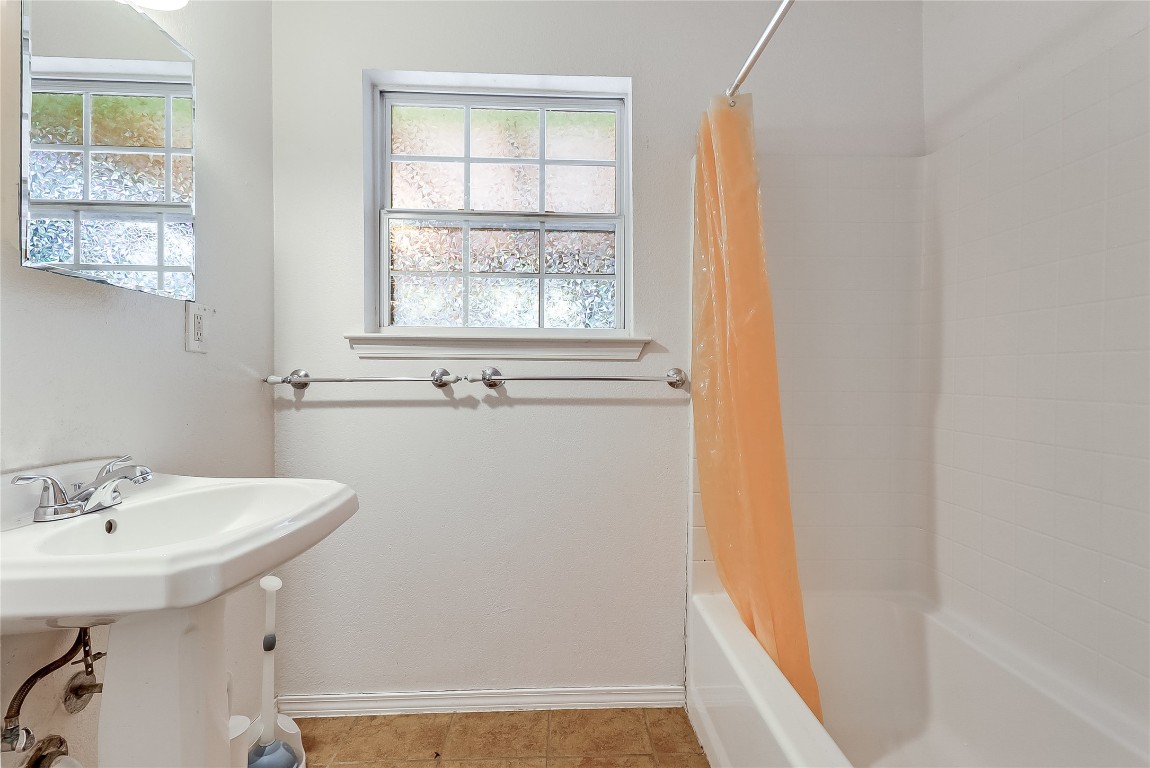 1706 Maple Avenue Austin, TX 78702 - Photo 17 of 30 a bathroom with a sink a mirror and a window