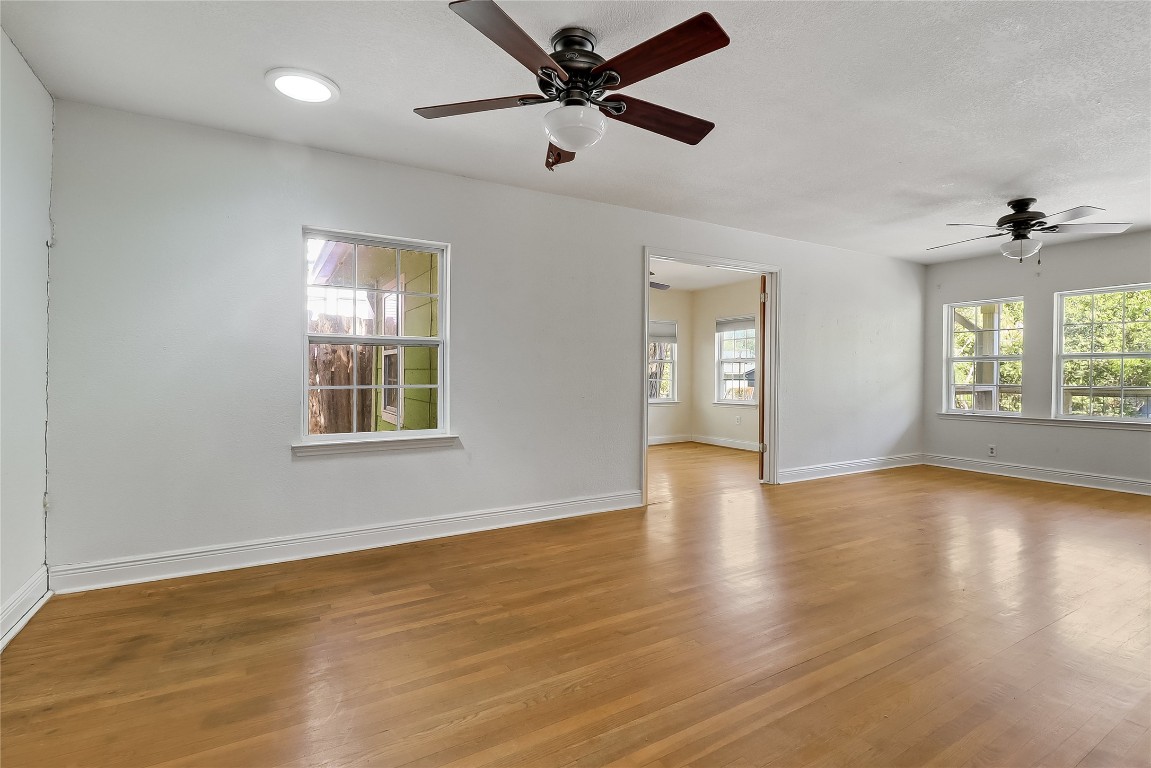 1706 Maple Avenue Austin, TX 78702 - Photo 5 of 30 a view of an empty room with a window and wooden floor