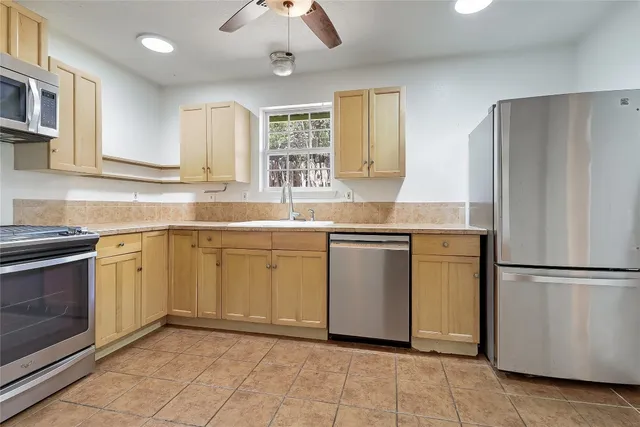 a kitchen with a sink stove and refrigerator
