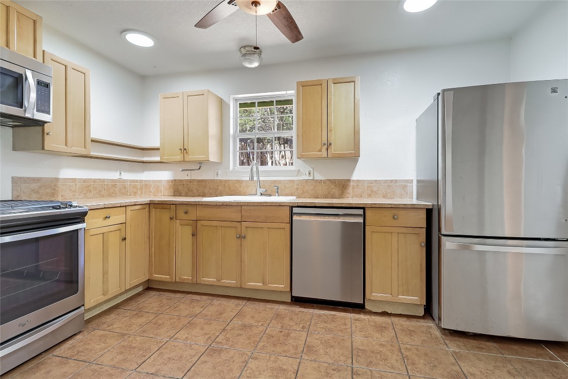 1706 Maple Avenue Austin, TX 78702 - Photo 8 of 30 a kitchen with a sink stove and refrigerator