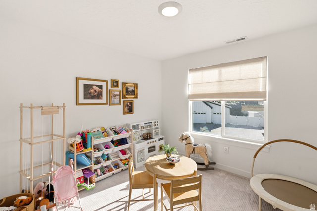 870 North Ada Loop Lehi, UT 84048 - Photo 35 of 51 Bright room featuring white walls, a large window with Roman shades, recessed lighting, and light-toned carpeting