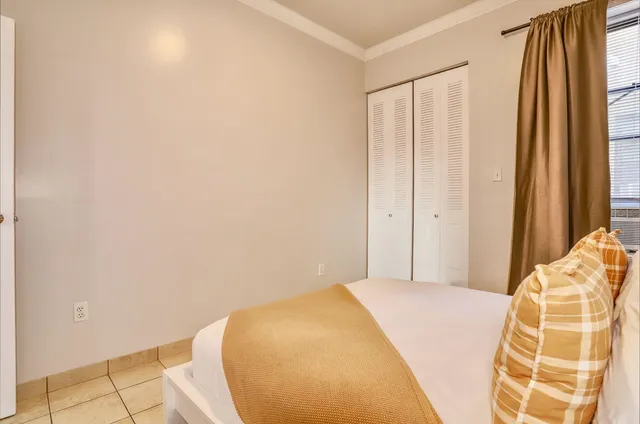 a bedroom with a bed and a window